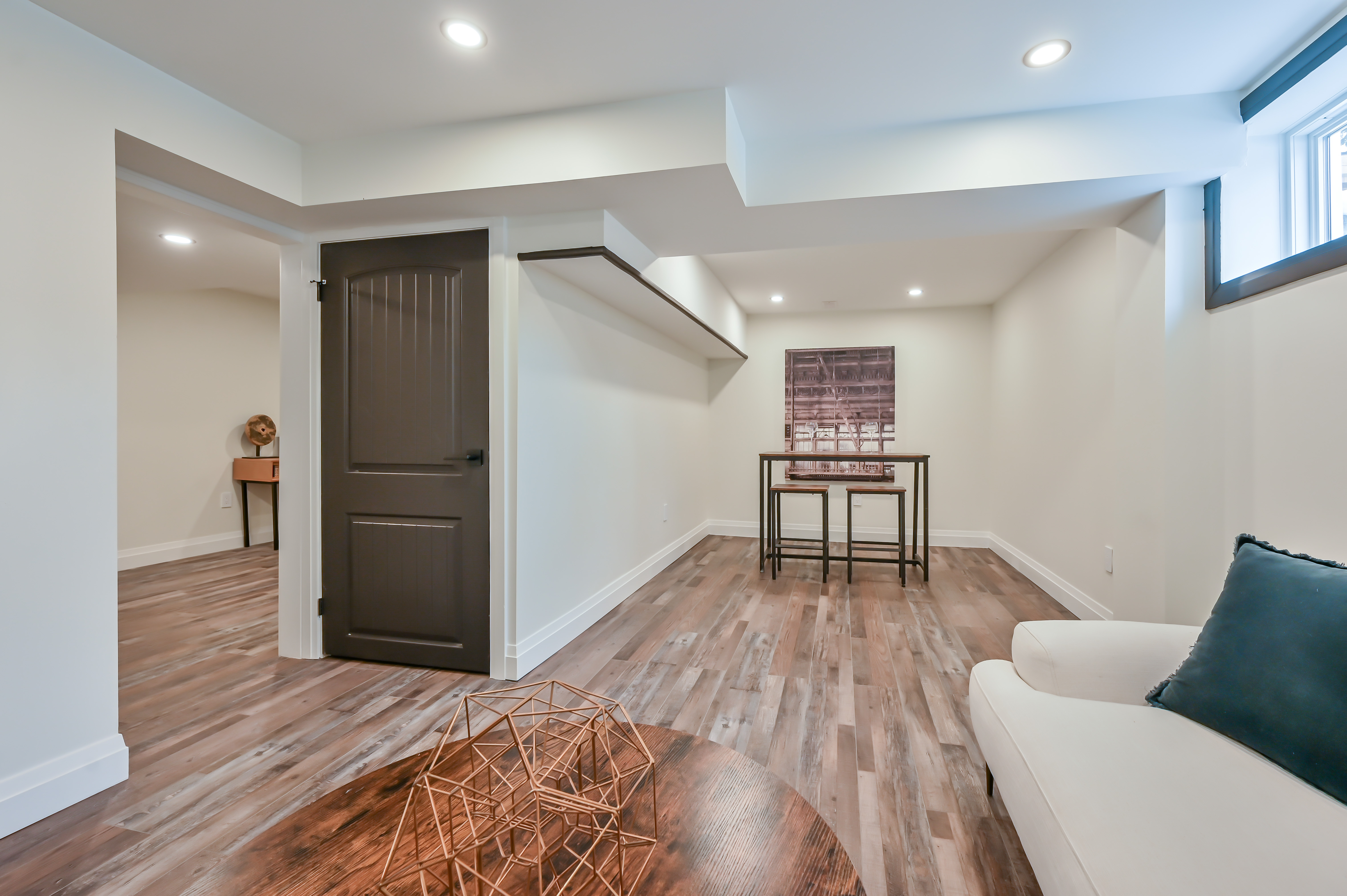 Professional finished basement with excellent lighting, staging, and wide-angle composition — premium portfolio shot — Kron, Hamilton | MTC Renovations